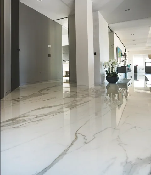 Polished white marble floor tiles in an open hallway installed by Stoneworks Singapore